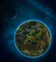 Hungary from space on Earth at night surrounded by space with Moon and Milky Way. Detailed planet with city lights and clouds.