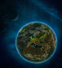 Bosnia and Herzegovina from space on Earth at night surrounded by space with Moon and Milky Way. Detailed planet with city lights and clouds.