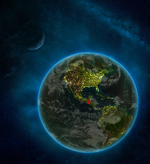 Guatemala from space on Earth at night surrounded by space with Moon and Milky Way. Detailed planet with city lights and clouds.