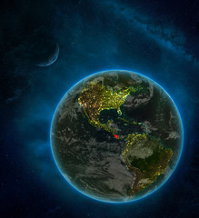 Costa Rica from space on Earth at night surrounded by space with Moon and Milky Way. Detailed planet with city lights and clouds.