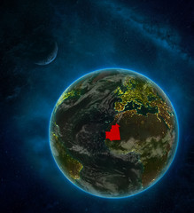 Mauritania from space on Earth at night surrounded by space with Moon and Milky Way. Detailed planet with city lights and clouds.