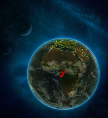 Congo from space on Earth at night surrounded by space with Moon and Milky Way. Detailed planet with city lights and clouds.