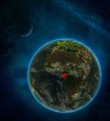 Gabon from space on Earth at night surrounded by space with Moon and Milky Way. Detailed planet with city lights and clouds.