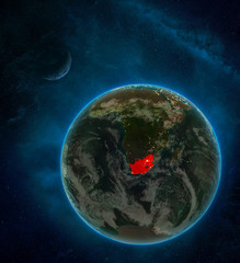 South Africa from space on Earth at night surrounded by space with Moon and Milky Way. Detailed planet with city lights and clouds.