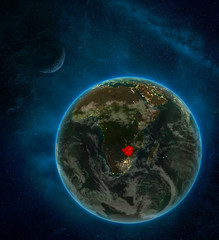 Zimbabwe from space on Earth at night surrounded by space with Moon and Milky Way. Detailed planet with city lights and clouds.
