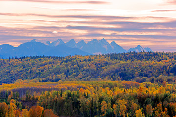 Autumn Scenery with Seven Sister Mountain Range and forest in prime fall colors at sunset.