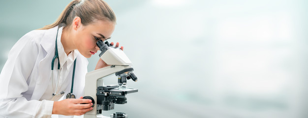 Scientist researcher using microscope in laboratory. Medical healthcare technology and...