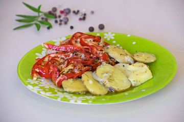 Baked potatoes and vegetables with spices. Stewed potatoes with tomatoes, sweet red pepper and spices.