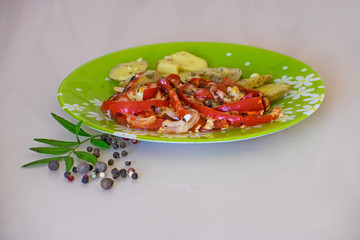 Baked potatoes and vegetables with spices. Stewed potatoes with tomatoes, sweet red pepper and spices.