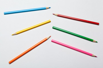 Wooden colorful ordinary pencils isolated on a white background