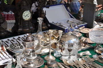 Old silver cutlery and dishes at flea market in Verona