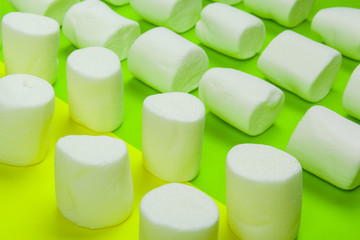 sweet marshmallow, candy on green background, top view