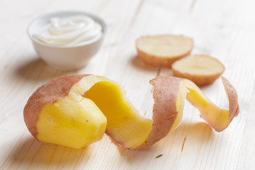 Fresh potatoes on the wood background