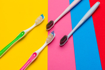 Flat lay composition with manual toothbrushes on color background, close up