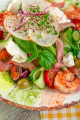 Fresh seafood salad served with prawns and greens