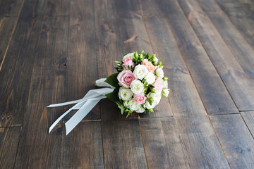 Wedding bouquet of roses on a wooden background close-up with a free place for an inscription