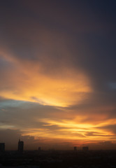 Fototapeta premium Golden sunset of cloudy sky over the city.