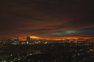 Fototapeta na wymiar Twilight vivid orange sky over cityscape.