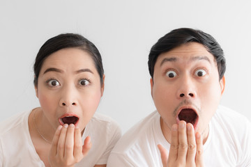 Surprised over couple funny face in white t-shirt and white background.