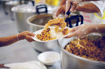 Poor people receive donated food from donors, Demonstrate mutual sharing in today's society : the concept of helping the needy