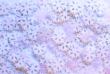 White artificial snowflakes on soft background. Winter background. Decorative template for cards, banners, posters.