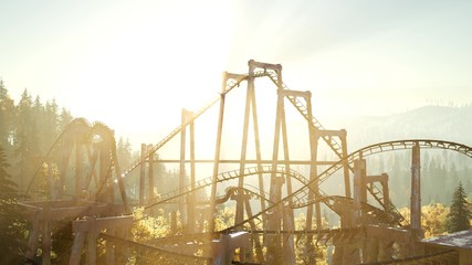 Fototapeta na wymiar old roller coaster at sunset in forest