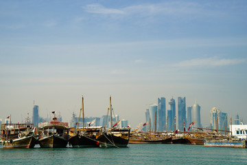 Doha port with boats and city skyline in distance