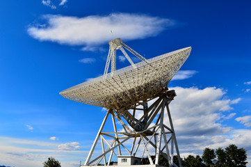 Array of satellite dishes or radio antennas against sky. Space o