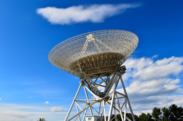 Array of satellite dishes or radio antennas against sky. Space o