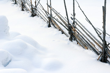 Old wooden fence in snow