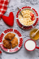 Breakfast on Valentine Day with red knitted heart
