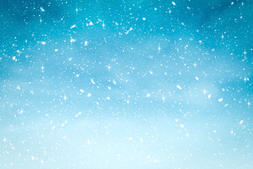 Winter background with snow and glitter in blue gradient color. Merry Christmas and Happy new year backdrop.