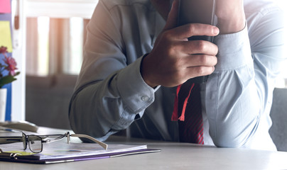 Medical doctor holding book or bible with on desk.