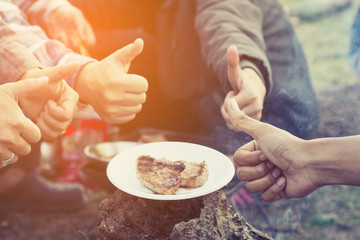 people camping at national park in holiday ; doing breakfast and activity at sunrise ; relaxing in nature 