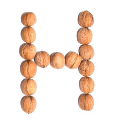 Letter H made with nuts to form a letter of the alphabet. Fruit letters on a white background.