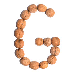 Letter G made with nuts to form a letter of the alphabet. Fruit letters on a white background.