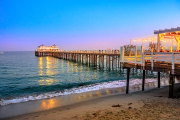 Deurstickers Schilderachtig kustlandschap & 39 s nachts verlicht van Malibu Pier in Malibu, Californië, Verenigde Staten, zie vanaf Carbon Beach. Malibu Pier is een historisch monument. Blue hour-opname. Ruimte kopiëren. © bennymarty