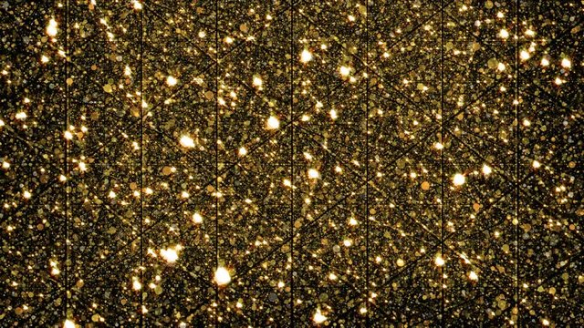 Abstract gold glitter particles falling down background.