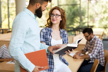 Group of college students studying at library