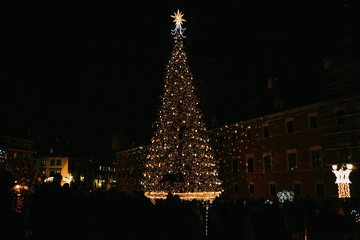 Decorated Christmas tree on the main square in Warsaw in Poland at night.