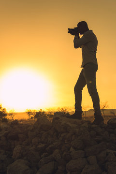 Black photographer at sunset