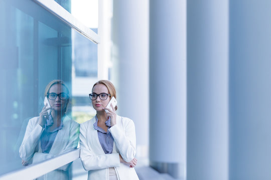 Portrait of beautiful business woman talking on the smartphone outdoor