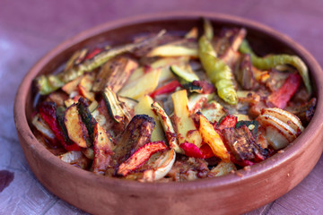 Angled positioned of onion, pepper, tomato meat meal in the traditional plate