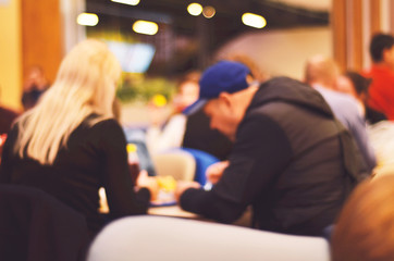 Blurred background. Blurred silhouettes of sitting people in coffee