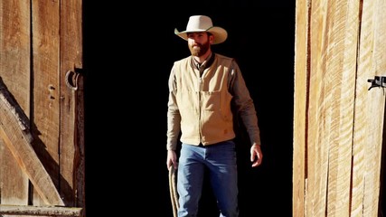 Cowboy Ranch hand with horse on Dude Ranch in Corral Canada