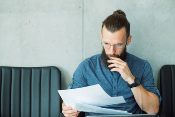 focused man reading documents. information finance report data sheet concept.