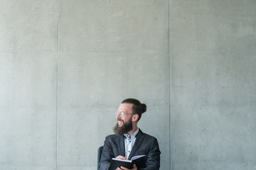 smiling man looking sideways holding day planner . business training seminar