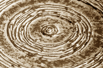 Fototapeta na wymiar Part of old ceramic plate close-up in brown tone.