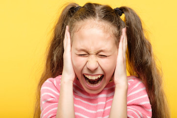 frightened petrified screaming girl covering her ears. stress and emotional breakdown.