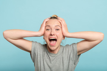 overexcited and enthusiastic woman screaming with happiness. female holding head in hands. emotion...